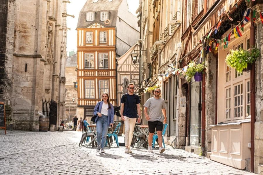 the town centre of Rouen in France with medieval buildings and people walking around